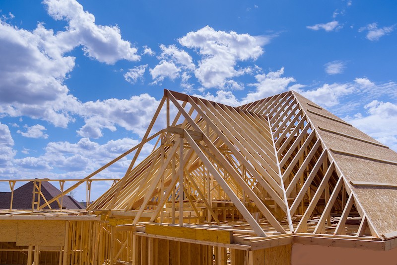 A wooden structure of a roof depicting the many roof parts essential for durability.