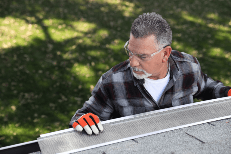 man installing gutter guards