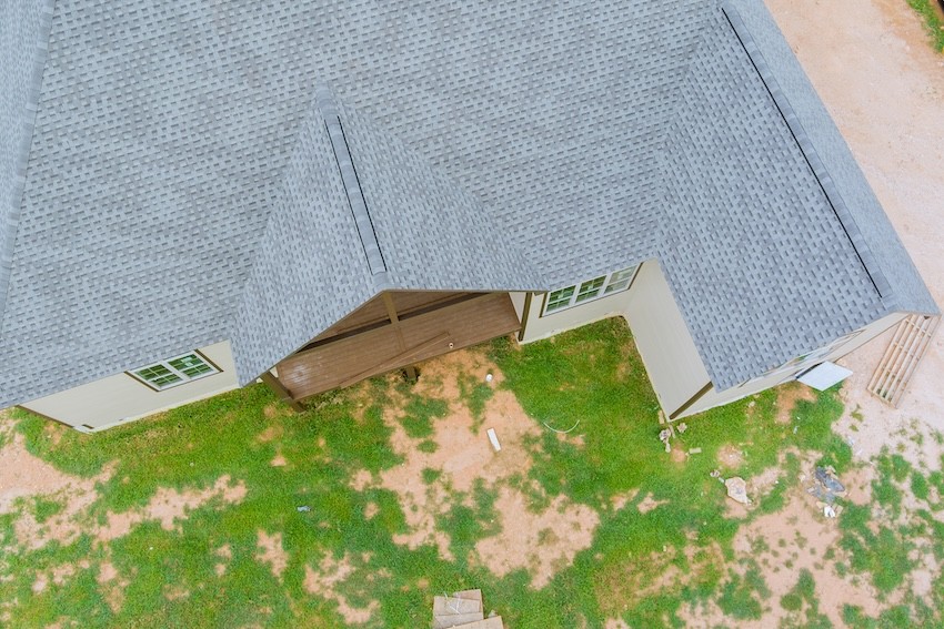 Roofing construction on a part of the new house covered in asphalt shingles