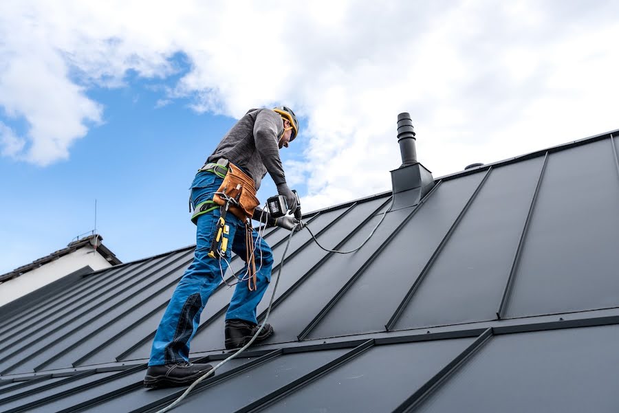 Man on roof doing repairs on roof