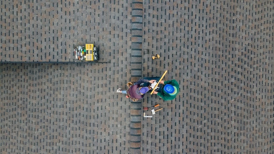 image of men working on a roof