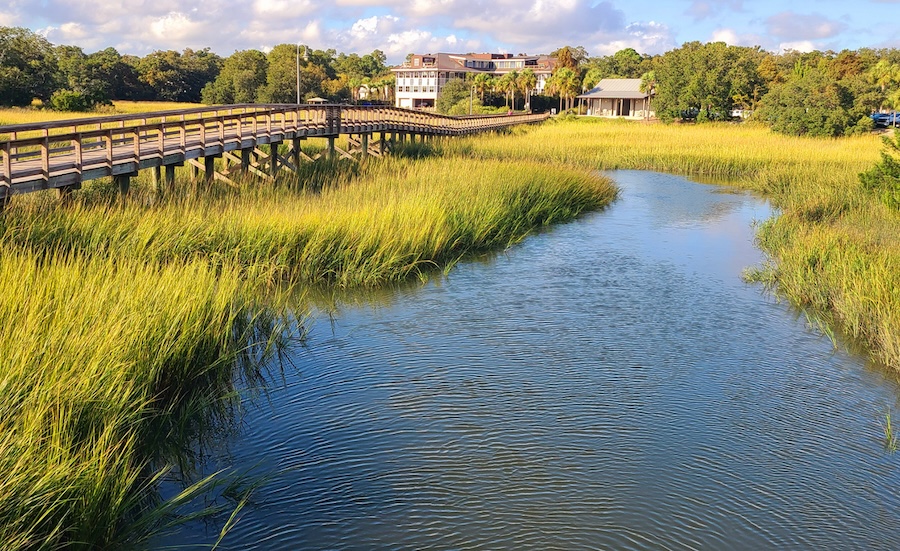 An image of a house and boardwalk on the marsh